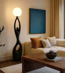 Sculptural modern floor lamp with abstract human form and glowing sphere light