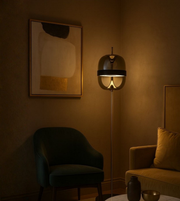 Modern floor lamp with helmet-shaped shade and warm ambient glow