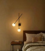 Adjustable double globe wall sconce with modern black metal frame