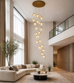 Luxora Cascade Multi-Drop LED Chandelier, double height Daya Worldwide lighting fixture with elegant multi-tier design and glowing LED drops.