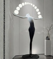 Sculptural floor lamp from Daya Worldwide's Aura Balance collection, featuring a modern statue design with a sleek metal finish.