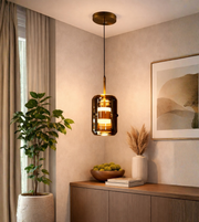 Modern smoke glass cylinder pendant light with warm glow in contemporary living room interior