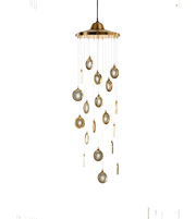 Decorative hanging light fixture with gold accents on a white background