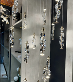 Crystal chandelier hanging from the ceiling with a blurred background