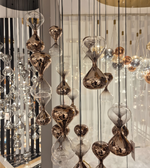 Decorative hanging lights with glass and metal design in a room setting.