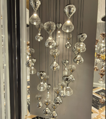 Chandelier with glass droplet design in a room setting