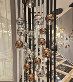 Modern chandelier with glass shades in a stylish interior setting.