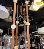 Chandelier with long arms and round lampshades in a showroom setting