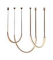 Set of three pendant lights with brown cords on a white background