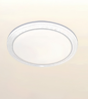 A round flush-mount LED ceiling light fixture with a clear acrylic outer ring and a white diffuser in the center, shown against a plain off-white background.