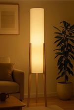 Nordic style floor lamp emitting warm light in a living room setting
