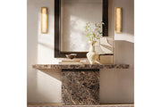 Pair of slim wall sconces mounted beside mirror for accent lighting