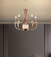 Modern gold chandelier with five candle-style LED lights in an elegant interior setting