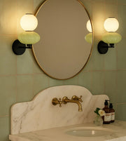 Daya Worldwide ORBA wall light with sleek modern design, mounted on a wall, emitting warm ambient glow.