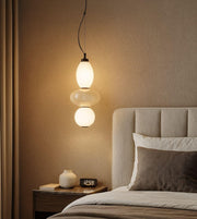 Daya Worldwide ORBLINE pendant light hanging with a sleek, modern design and warm ambient lighting.