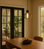 Daya Worldwide GLOWPOD pendant light hanging from ceiling with modern design and warm illumination in a contemporary space.