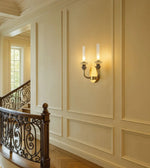 Elegant wall sconce lighting fixture on a classic staircase with ornate railing