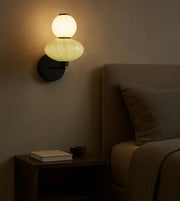 Daya Worldwide ORBA wall light mounted on a wall, featuring a modern design and warm lighting for contemporary decor.