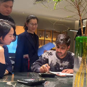 Group of people discussing at modern table with glass decor in luxury interior setting